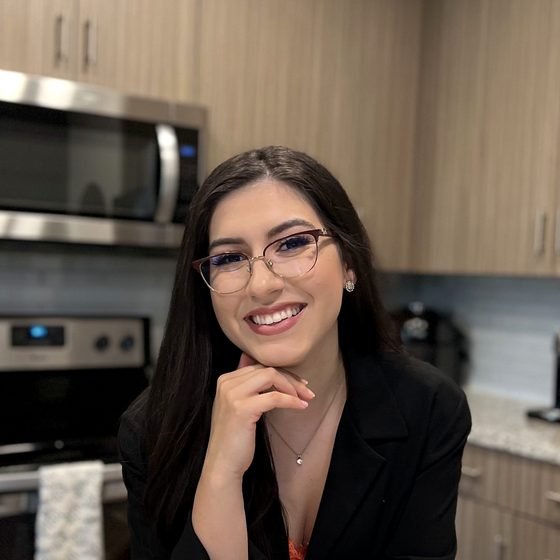 Vanessa Ribeiro, Registered Dietitian Nutritionist, at a kitchen counter.